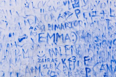 Europe, Portugal, Obidos. April 15, 2022. Blue graffiti names on a wall in Obidos. clipart