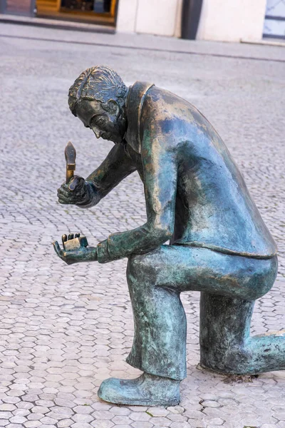 Stock image Europe, Portugal, Lisbon. April 18, 2022. Sculpture of a worker cutting cobblestones in Lisbon.