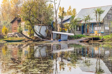 Rainawari, Srinagar, Jammu ve Kashmir, Hindistan. Dal Gölü kıyısında tekne ve evler.