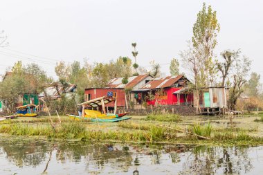 Rainawari, Srinagar, Jammu ve Kashmir, Hindistan. 2 Kasım 2022. Dal Gölü kıyısında tekne ve evler.