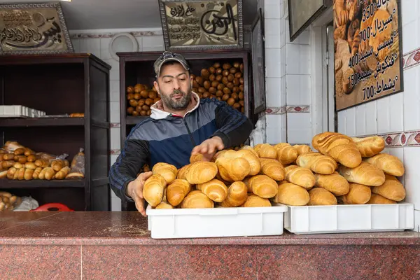 Stock image Tunis, Tunisia. March 11, 2023. Baker with loaves of bread in the Tunis Souk.