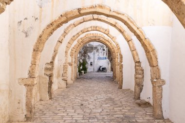 Houmt Souk, Djerba, Medenine, Tunisia. Arched passageway in the Houmt Souk. clipart