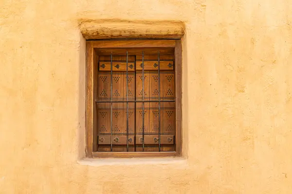Diriyah, Riyadh, Saudi Arabia, Middle East. Metal bars on a wooden shuttered window in the At-Turaif UNESCO World Heritage Site.