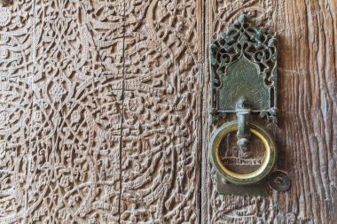 Khiva, Xorazm Region, Uzbekistan, Central Asia. Antique brass door knocker in Uzbekistan. clipart