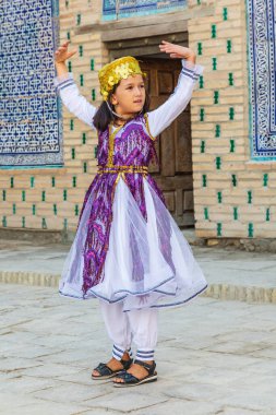 Khiva, Xorazm Bölgesi, Özbekistan, Orta Asya. 22 Ağustos 2021. Khiva 'daki geleneksel Özbek müzik grubunda çocuk dansçı.