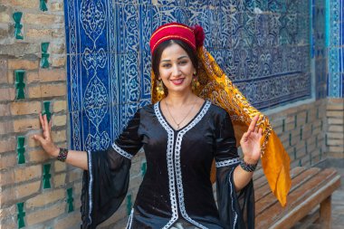 Khiva, Xorazm Region, Uzbekistan, Central Asia. August 22, 2021. Woman in traditional dress in Khiva. clipart