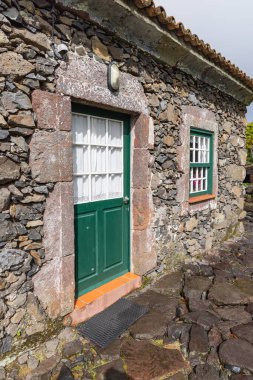 Aldeia da Cuada, Flores, Azores, Portekiz. 2 Nisan 2022. Taş bir binanın kapısı ve penceresi.