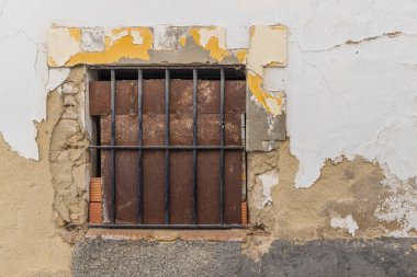 Arcos de la Frontera, Seville Province, Andalusia, Spain. Rusted metal blocking a barred window in an old building. clipart