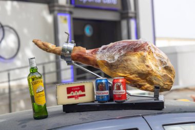 Andujar, Jaen Province, Andalusia, Spain. April 28, 2023. Street vendor selling Scotch Whisky, cheese, beer, and Iberico ham at a religious festival in Andujar. clipart