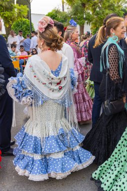 Andujar, Jaen Eyaleti, Endülüs, İspanya. 28 Nisan 2023. Andujar 'daki dini festivalde geleneksel giyinmiş bir kadın..