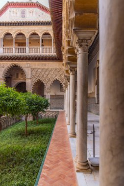 Casco Antiguo, Seville, Seville Province, Andalusia, Spain. May 5, 2023. A courtyard at the Alcazar of Seville, a former Moorish citadel. clipart