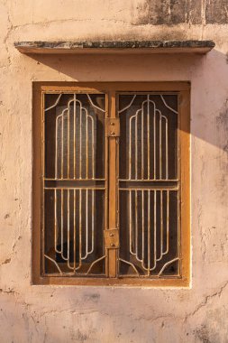 Devnagar, Ajmer, Rajasthan, India. Barred window on a building in Rajasthan. clipart