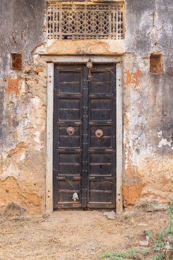 Killa, Degana, Rajasthan, India. Old wooden door on a building in Rajasthan. clipart