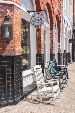 Lockhart, Texas, United States. March 14, 2022. Rocking chairs on a sidewalk in a small Texas town. clipart