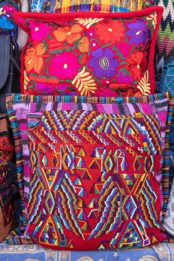 San Juan La Laguna, Solola, Guatemala. Pillows made from colorful traditional woven cloth at a market near Lake Atitlan. clipart