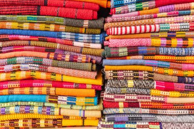 San Juan La Laguna, Solola, Guatemala. Colorful traditional woven cloth for sale at a market near Lake Atitlan. clipart