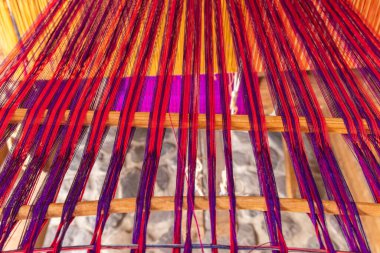 San Antonio Palopo, Solola, Guatemala. Colorful threads on a loom near Lake Atitlan. clipart