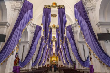 Antigua Guatemala, Sacatepequez, Guatemala. March 8, 2024. Purple banners hanging in the Church of Mercy in Antigua Guatemala. clipart