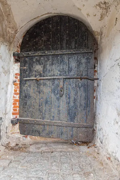 Fredriksten Kalesi, Halden, Ostfold, Norveç. 3 Kasım 2024. Tarihi Fredriksten Kalesi 'ndeki taş bir binanın üzerinde siyah ahşap bir kapı..