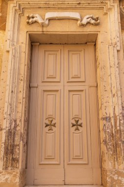 Malta, Birgu. Saint Lawrence Kolej Kilisesi. Dışarıdan. Malta Haçı ile kapı detayı.