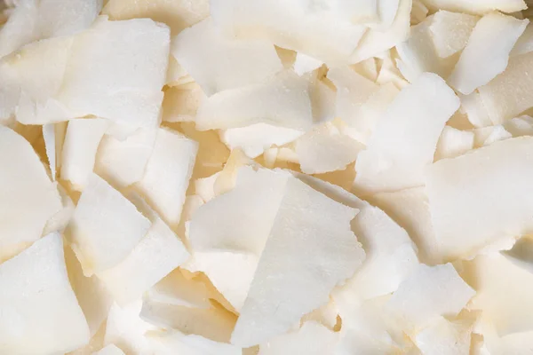 stock image The texture of coconut flakes as a background. A close shot of a coconut. Macro photo.Coconut flakes.