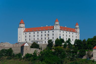 Bratislava, Slovakya. 15 Ağustos 2023. Bratislava Şatosu, Tuna Nehri 'nin üzerindeki küçük Karpatlar' ın kayalık tepesinde dört köşeli kuleleri olan dikdörtgen bina.