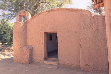 Rustic adobe chapel with simple bell tower, showcasing traditional architecture. Catamarca, Argentina