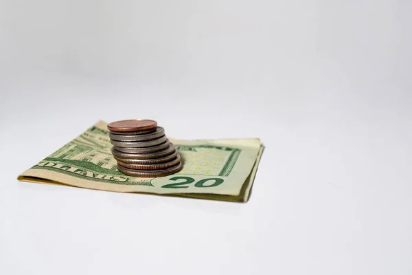 stock image Building a financial future: cash, a 20 dollar bill with coins stacked on top