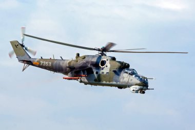 military helicopter in flight in blue sky - Mi-24 Hind