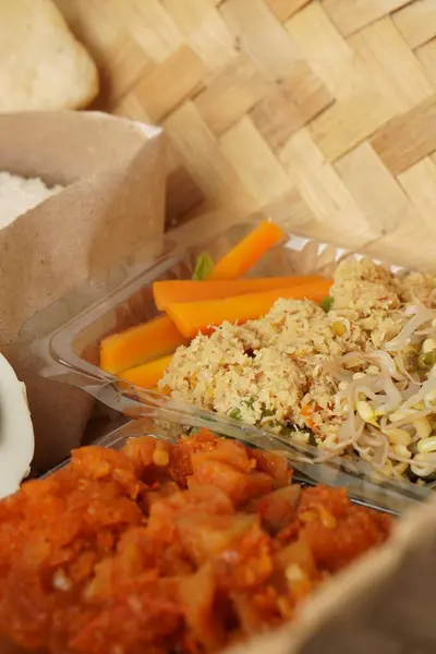 Enfes detaylar: Urap sebzeler ve bambu kabında sergilenen baharatlı patates sambal mutfak başyapıtı.