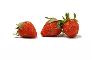 Fresh, ripe strawberries (Fragaria  ananassa) with vibrant red color, photographed against a white background. Perfect for eating fresh or as an ingredient in recipes. clipart