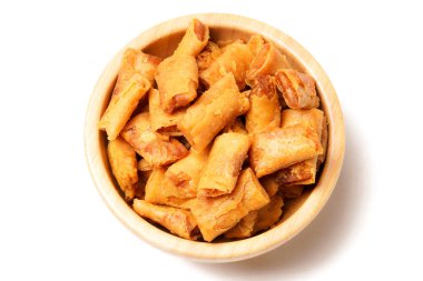 A bowl of Sumpia, Indonesian traditional mini spring rolls filled with shrimp floss. The crunchy outer wrapper is deep-fried to perfection. Photographed on a white background. clipart