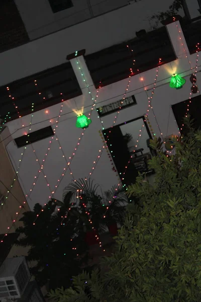 stock image christmas lights on a background of a modern apartment building