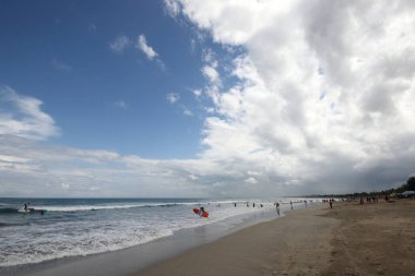 a view of a beautiful landscape with a large beach with blue sky and clouds