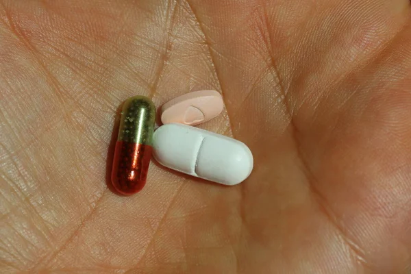red and orange capsules on the table, medicine