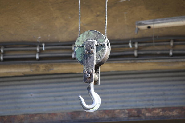 crane hook hangin over a car workshop