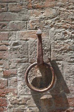 Tarihi İtalyan duvarına tutturulmuş paslı bir demir at kravatı.