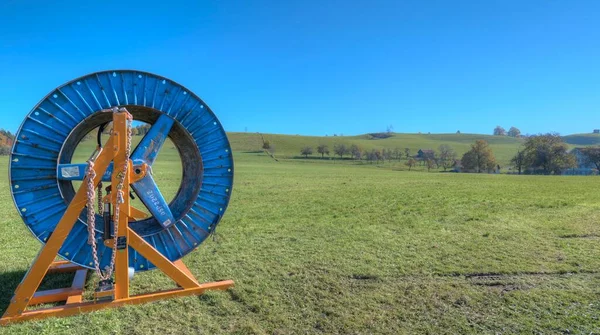 Landscape with large industrial cable reel and in HDR