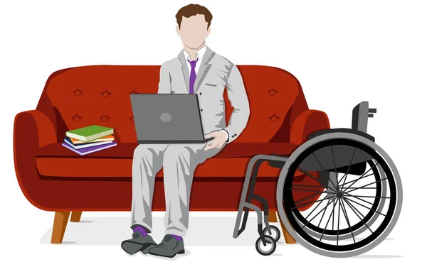 ソファの上でコンピューターを操作する男が車椅子を横に並べて — ストック写真