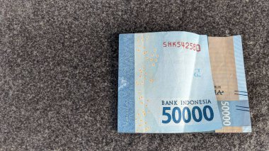 Indonesian currency denominated in 50000 rupiah or 50k rupiah. clipart