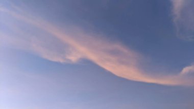 A beautiful sunrise sky with shades of blue, purple, orange, and pink. The clouds are wispy and form interesting patterns. The horizon is barely visible, blending into the sky. clipart