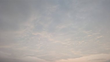 Üstü mavi-griden alta yumuşak bir pembeye kadar yumuşak bir eğimle engin bir gökyüzü. Gökyüzü ışıkla, ince bulutlarla doludur. Narin, dokulu ve huzurlu bir atmosfer yaratırlar..