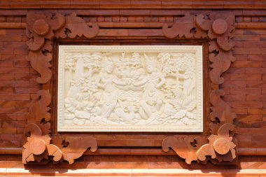 Traditional Balinese stone sculpture art and culture on a stone wall