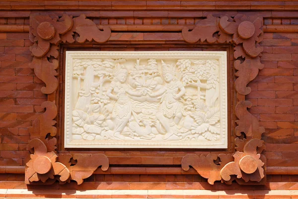 Traditional Balinese stone sculpture art and culture on a stone wall