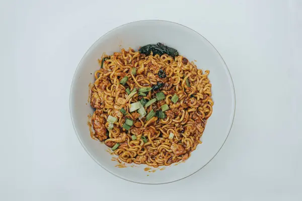 stock image Mie Bangladesh with boiled egg and some vegetables made from instant noodles originate from Medan or Aceh. Typical Southeast Asian food. Flat lay or top view angle with the object in the center. Isolated white background.