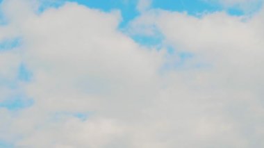 Mavi gökyüzü arkaplanından geçen bulutların hızlandırılması