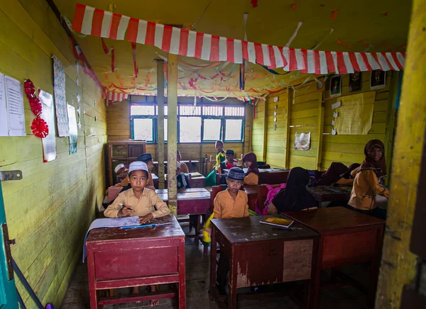 stock image Elementary School Students were studying  together in a traditional class in a village in Barito Kuala, Indonesia.