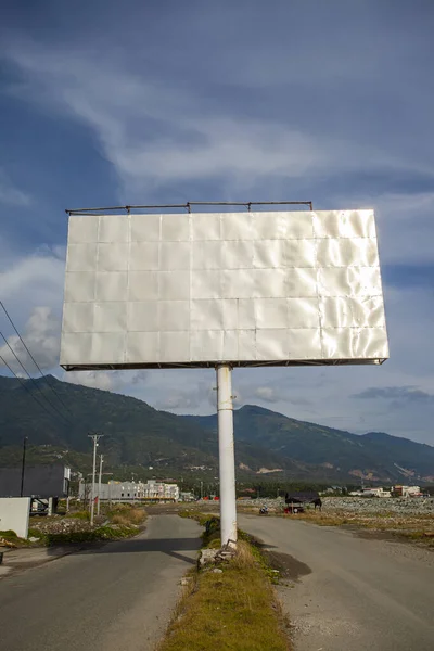 Blank billboard ready for new advertisement with blue sky background. Mock up.