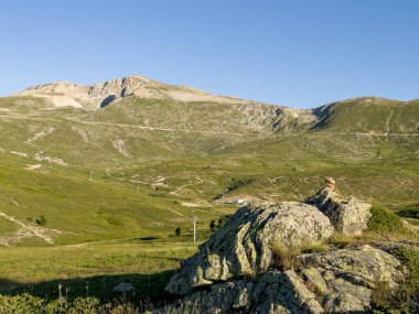 Ön planda çayırlar, arka planda Bursa 'da Uludağ, erimiş karıyla, mavi gökyüzüyle Uludağ tamamen gözler önüne serildi. Yüksek kalite fotoğraf