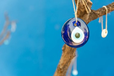 Ağaçta asılı nazar boncuğu, mavi arkaplanı olan metin için boşluk. Yüksek kalite fotoğraf